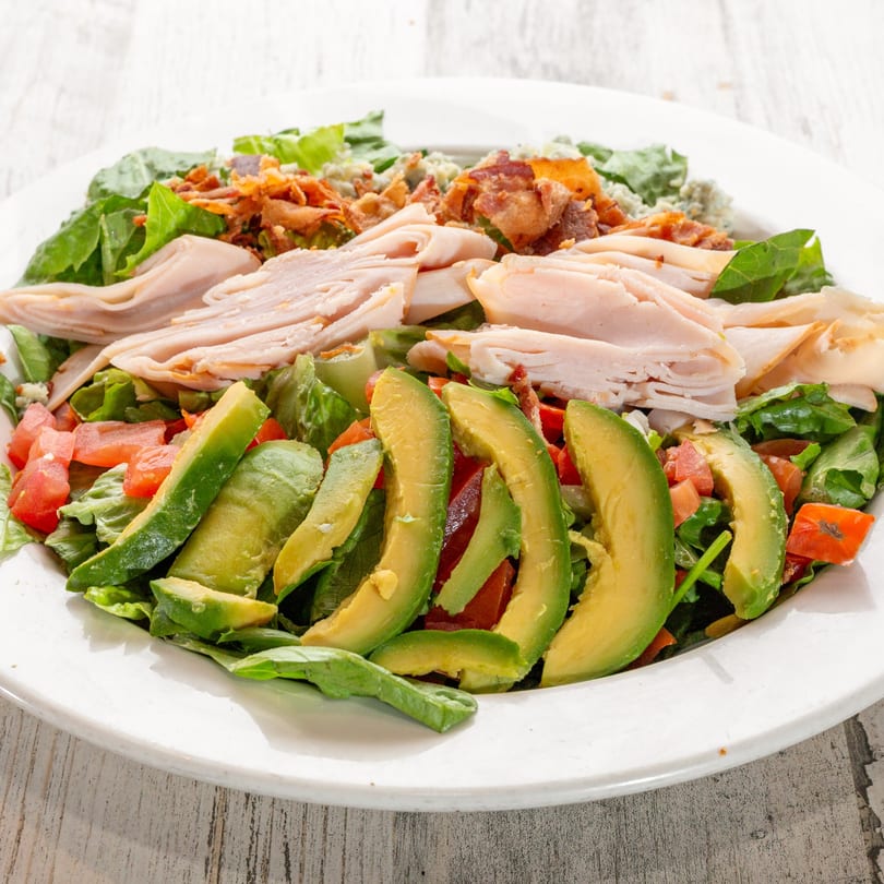 A White Wolf Cafe Cobb salad with turkey, avocado, bacon, tomatoes, and blue cheese crumbles.